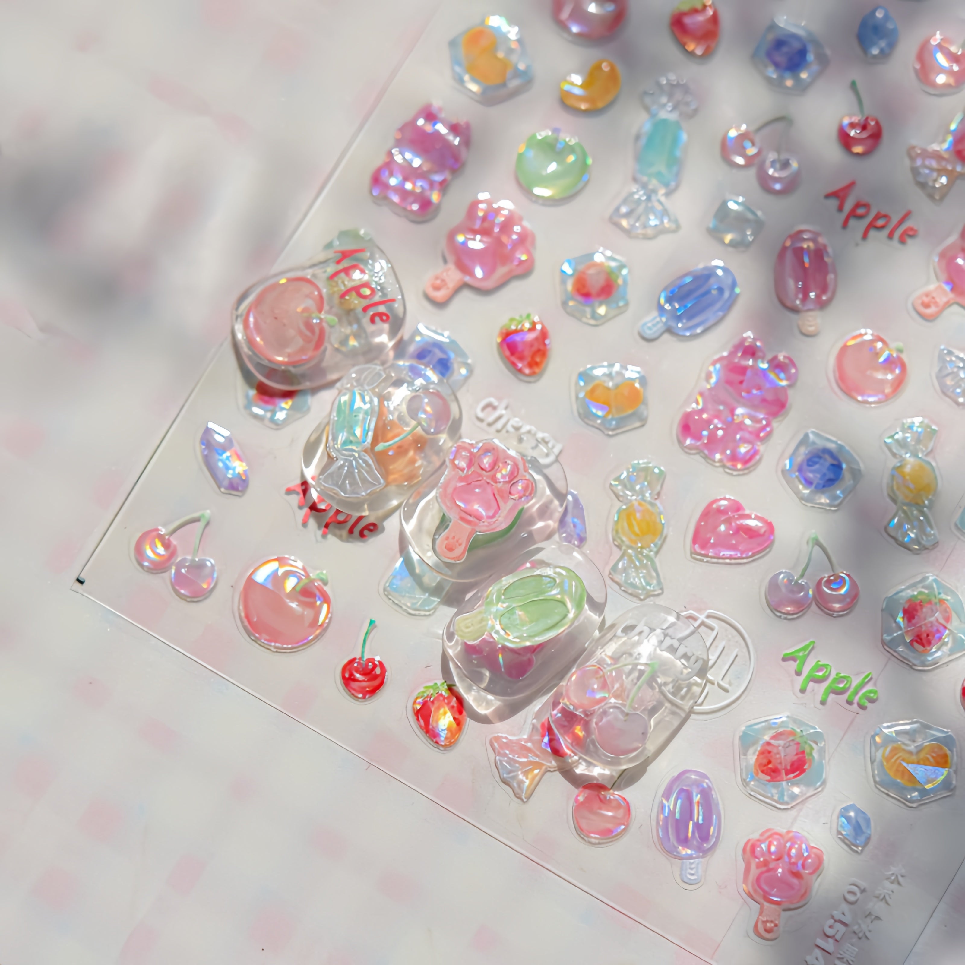 Colorful decorative Nail stickers on sheet with 'Apple' text