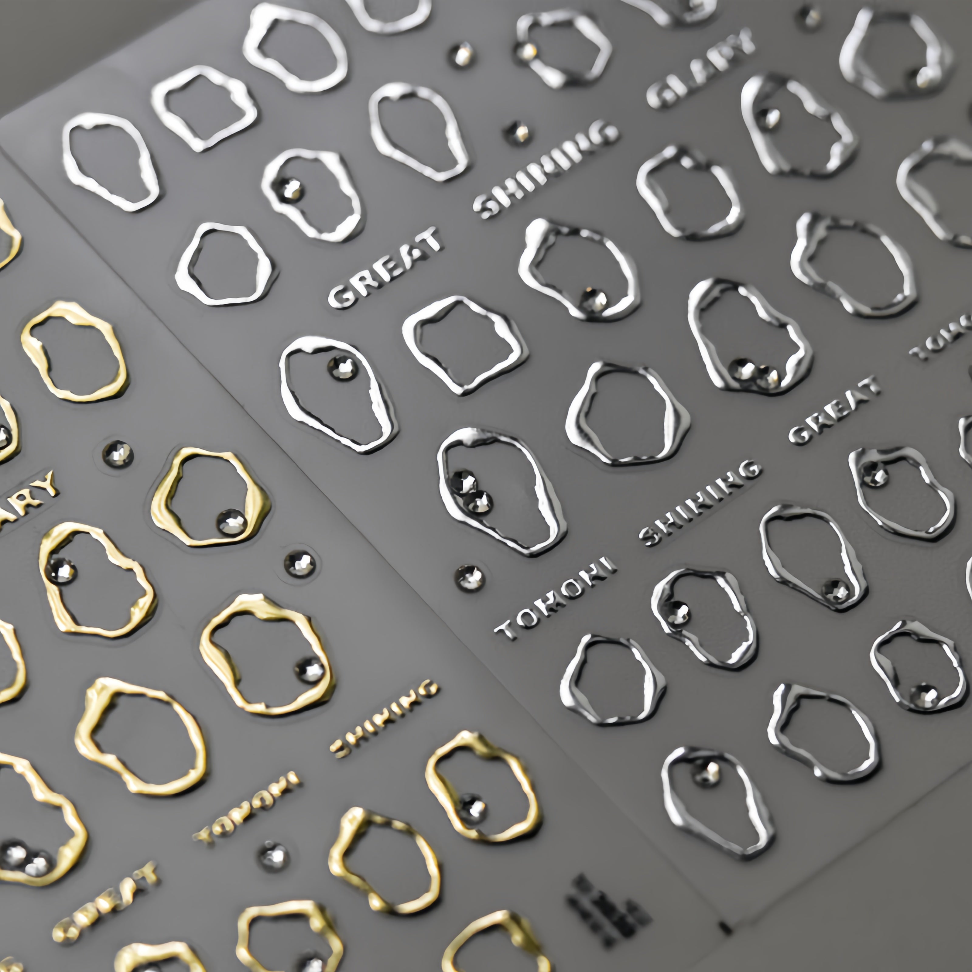 Metallic nail art stickers with geometric shapes and 'GREAT SHINING' text 