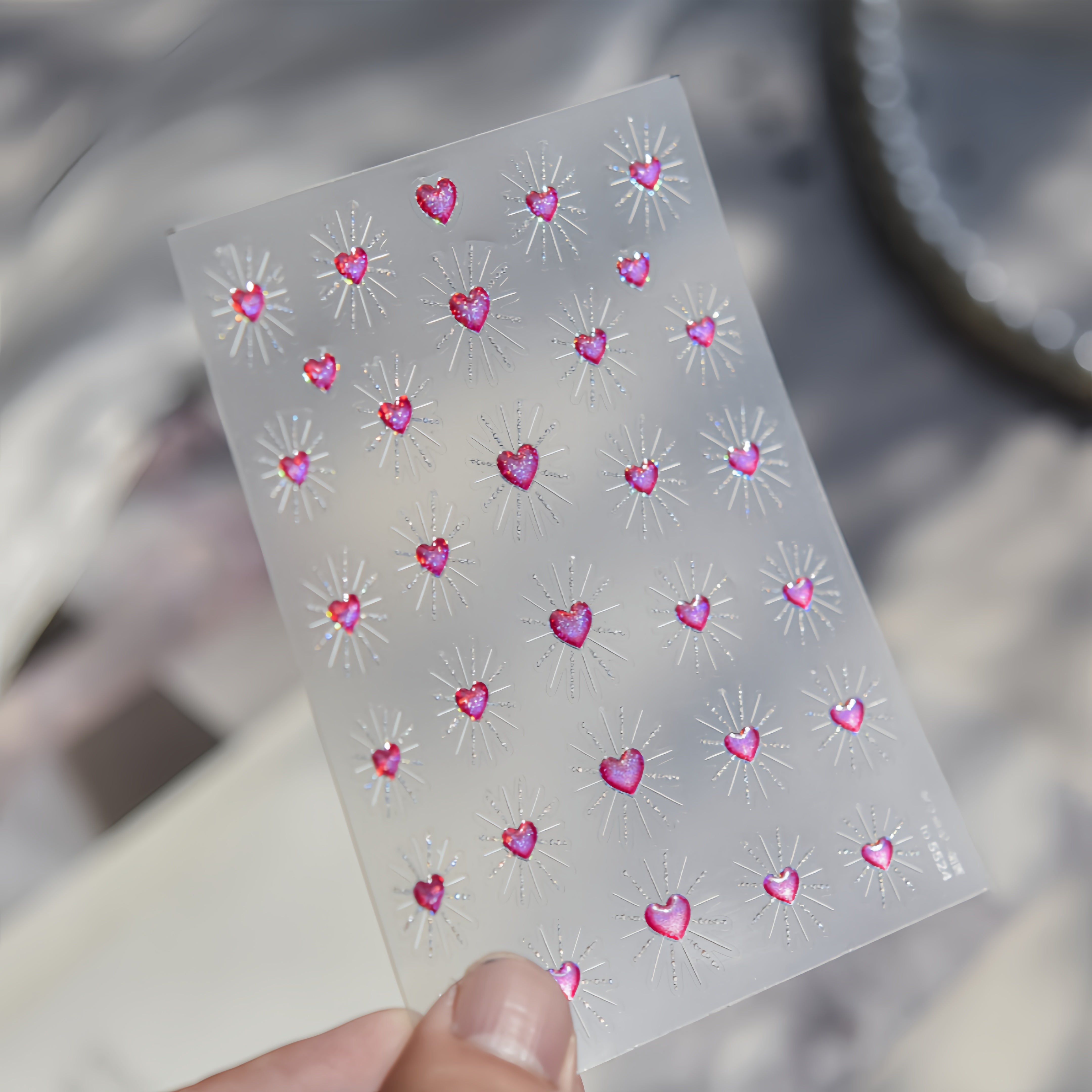 Sheet of pink heart-shaped nail stickers 