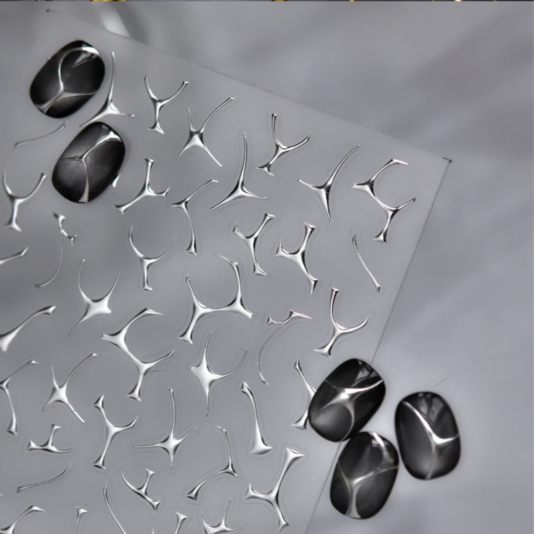 Metallic decorative sheet with embossed pattern and three metallic stones 