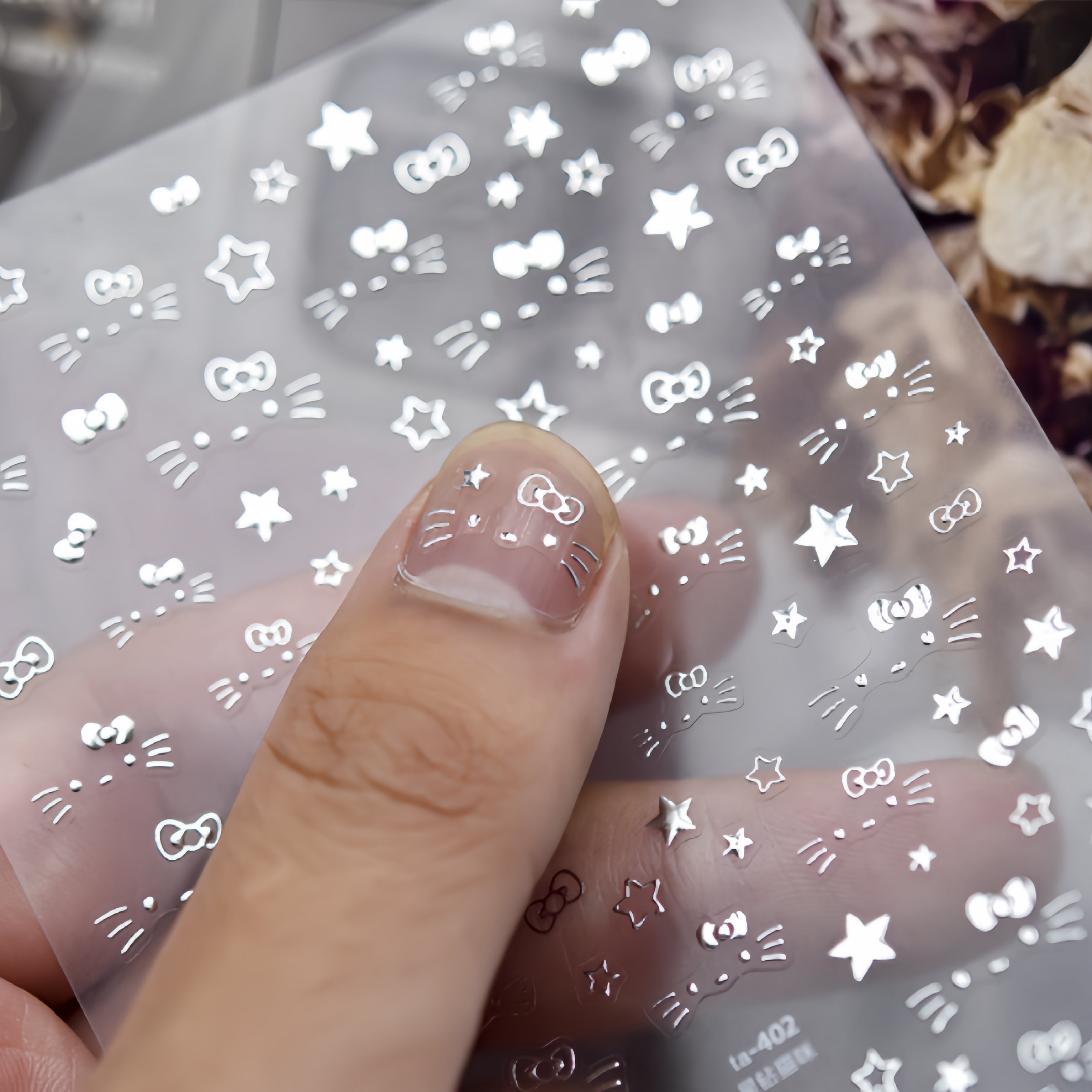 Nail art stamping plate with star and bow designs