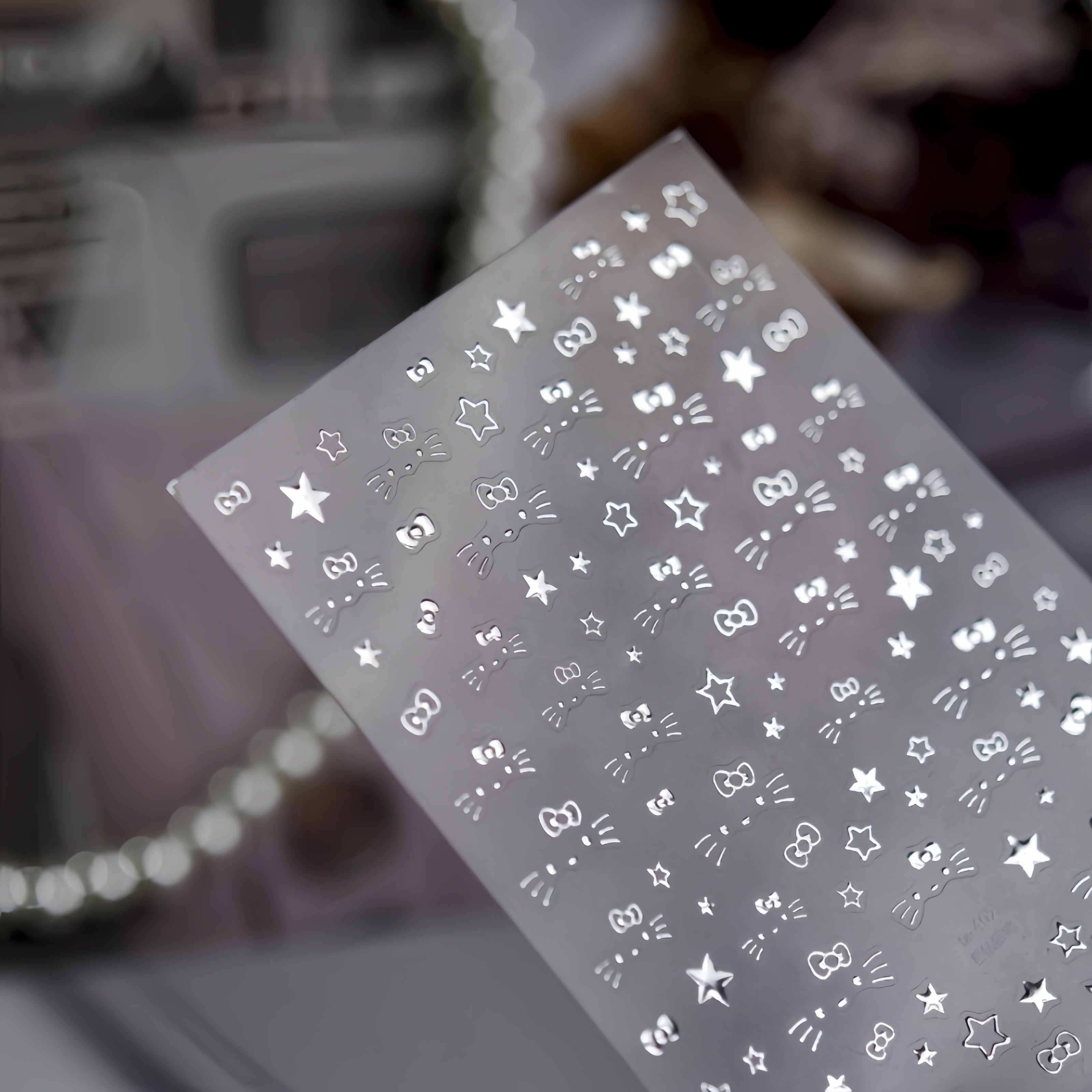 Sheet of star and bow nail stickers